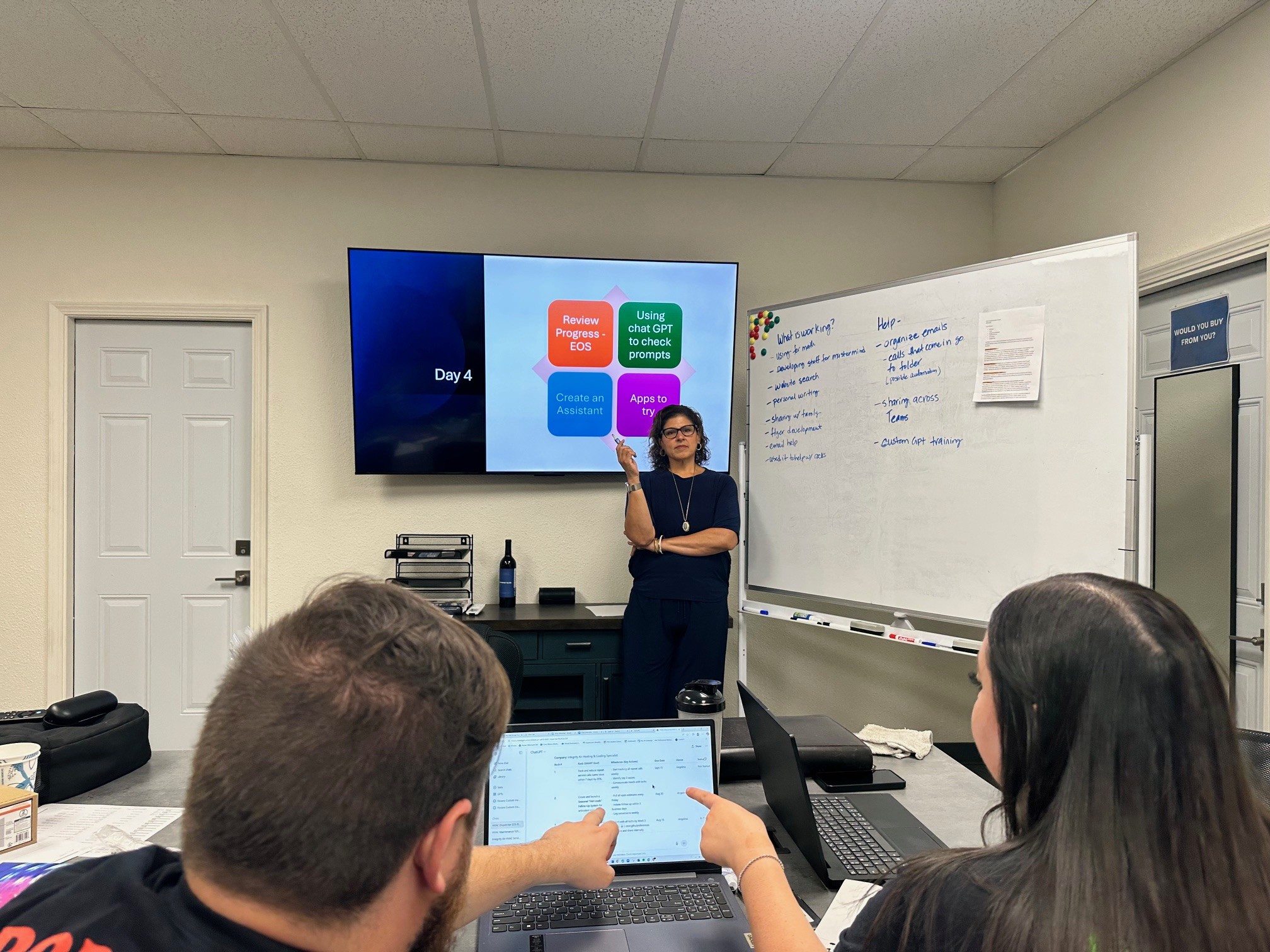 Vivian Welsh leading a training session with a whiteboard capturing team feedback